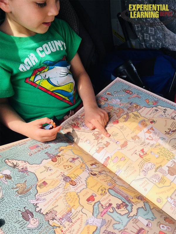 Learning activities for road trips - kid looking at a map while driving