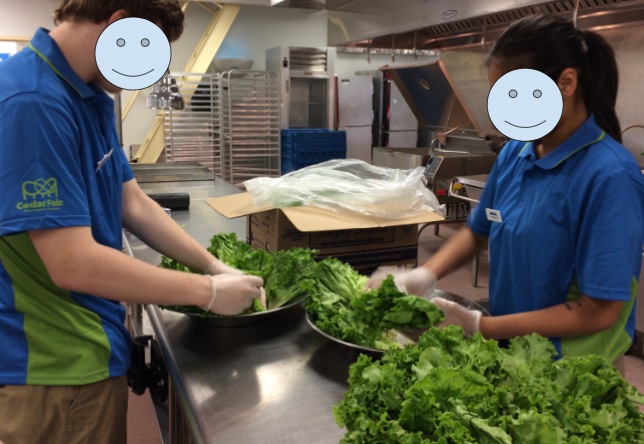 Students fundraising by volunteering in a kitchen of a local amusement park. 