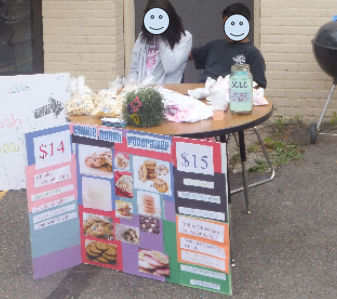 A photo of students running a bake sale.